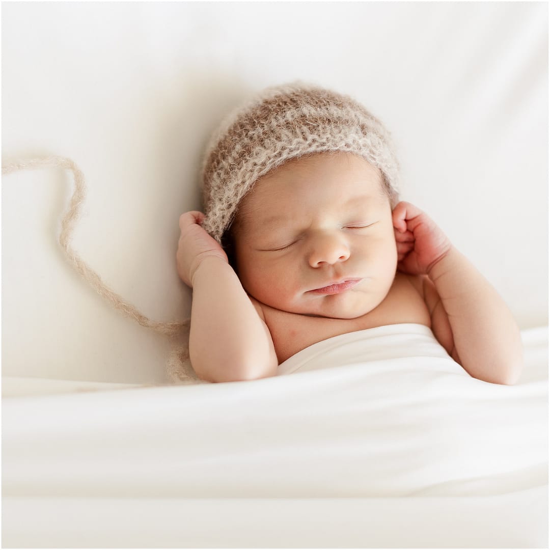 Baby boy in knit bonnet at Boise newborn studio session. Photo by Tiffany Hix Photography.