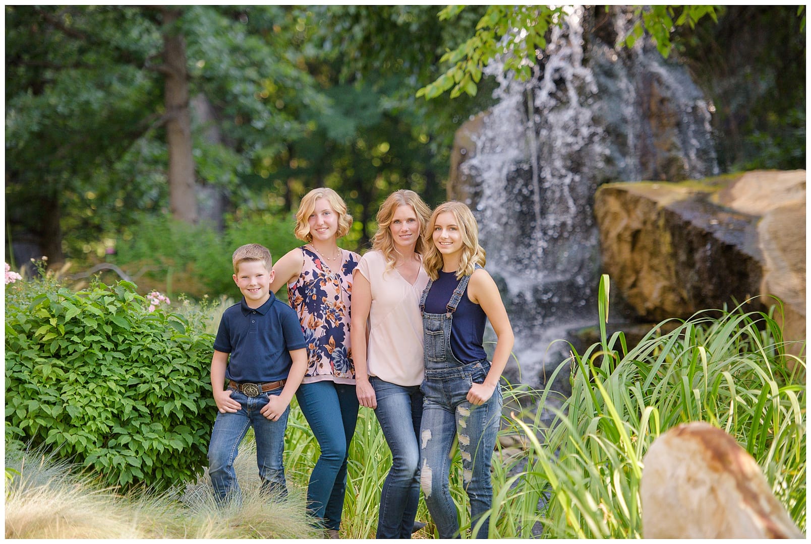 Boise family stands in front of waterfall. Photos by Tiffany Hix Photography.