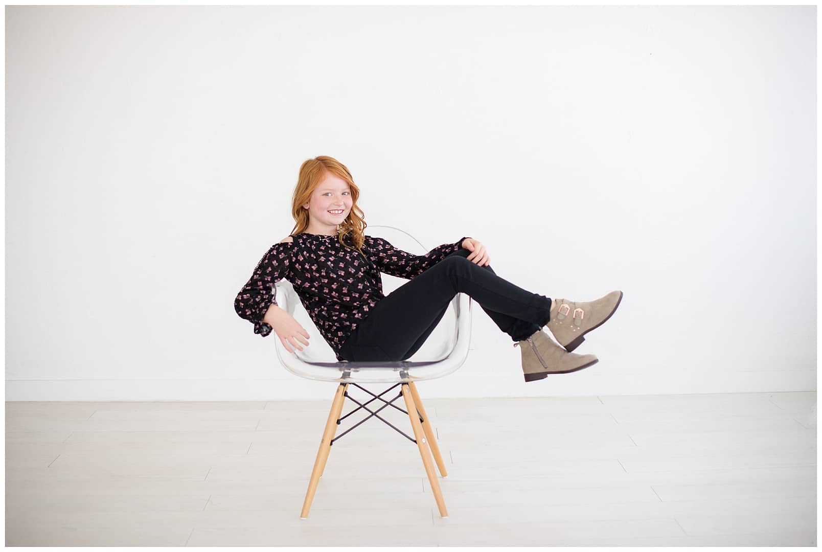 Red headed girl sits in chair for portrait. Photos by Tiffany Hix Photography.