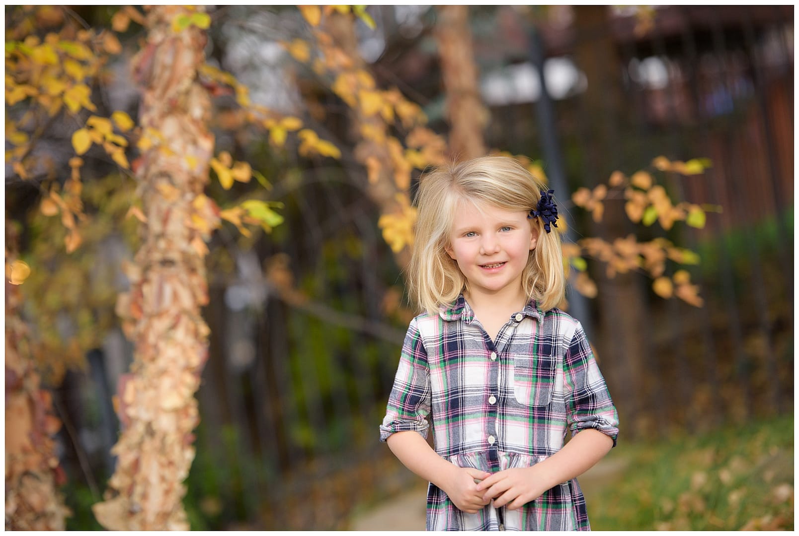 Blonde girl in plaid shirt. Photo by Tiffany Hix Photography