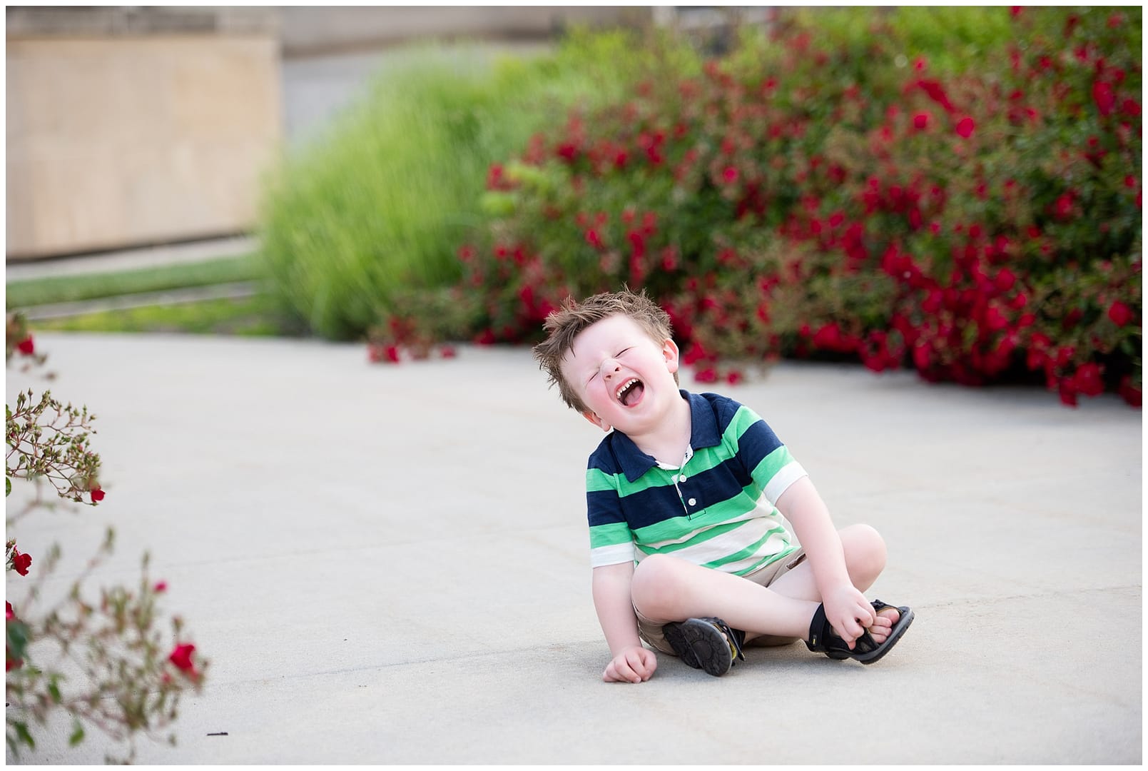 Boy laughs on sidewalk in Boise. Photos by Tiffany Hix Photography.