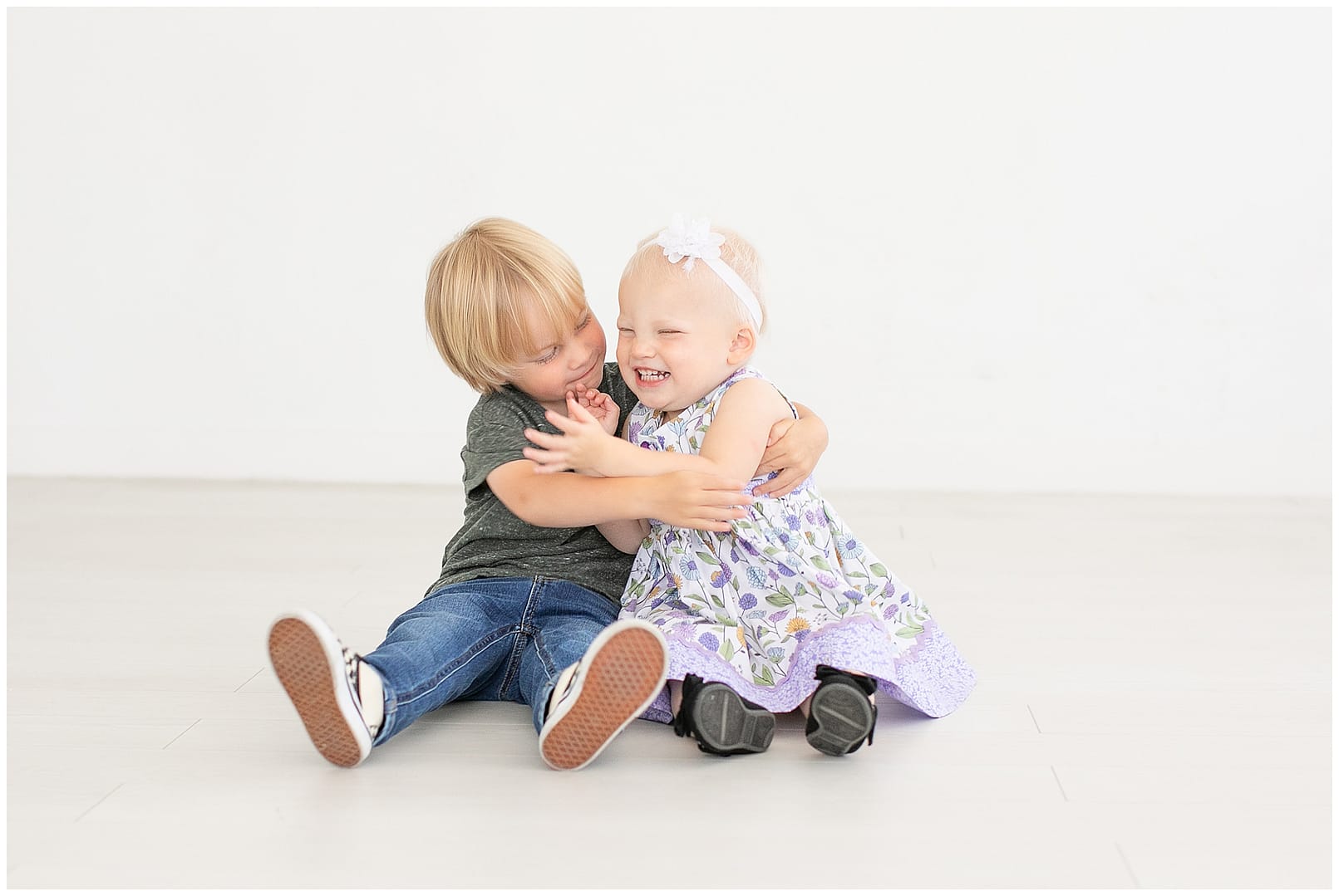 Siblings hug in studio. Photos by Tiffany Hix Photography.