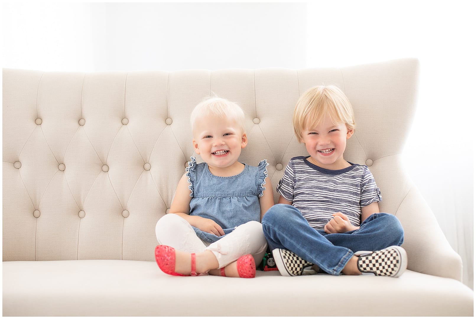 Children smile for portrait in studio. Photos by Tiffany Hix Photography.