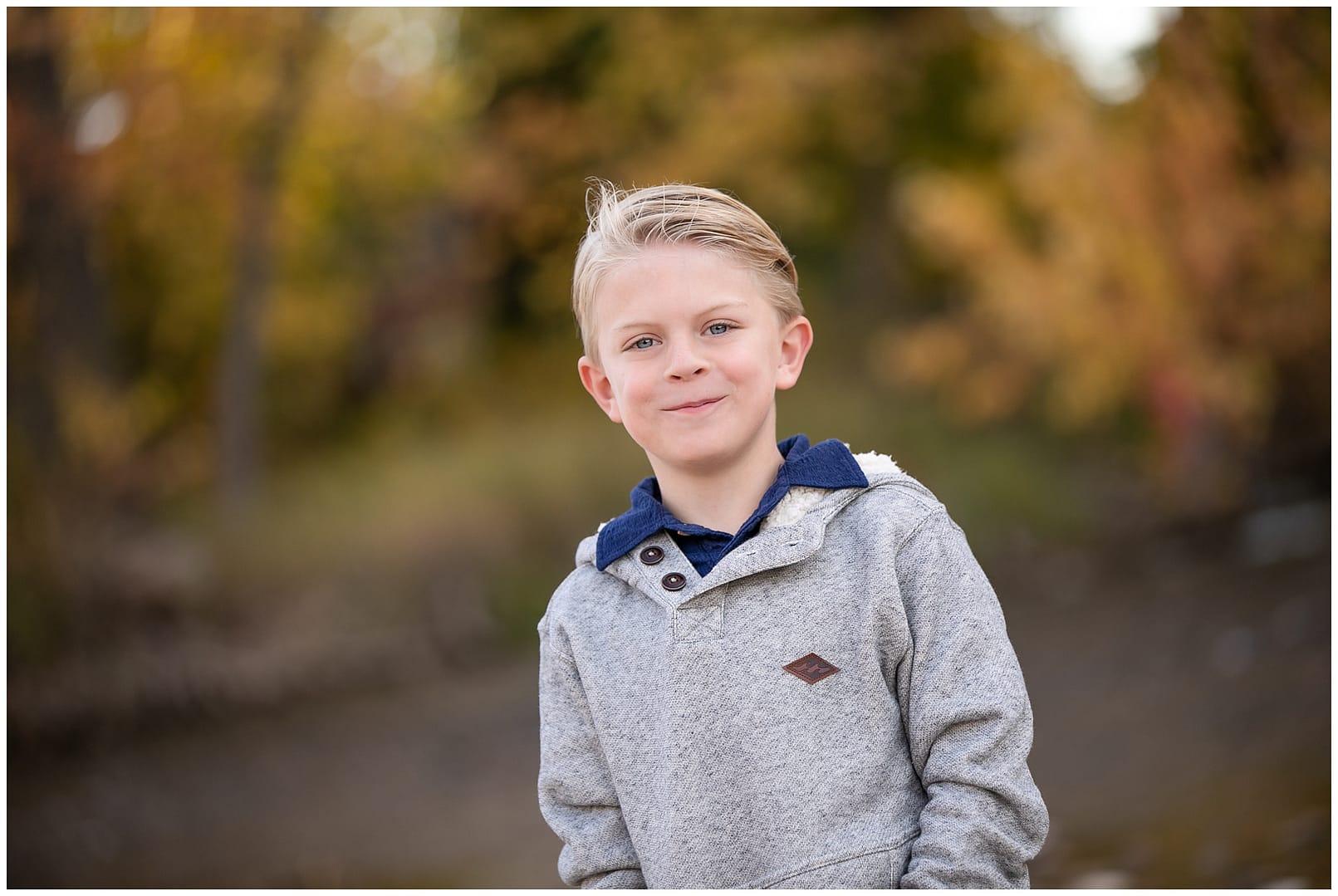 Young boy smiles during family portraits in Boise. Photos by Tiffany Hix Photography.