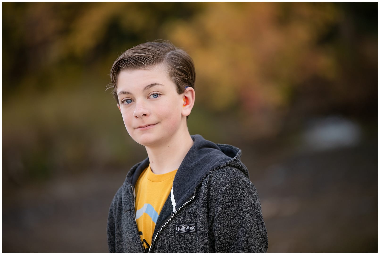 Young tween boy in gray hoodie. Photos by Tiffany Hix Photography.
