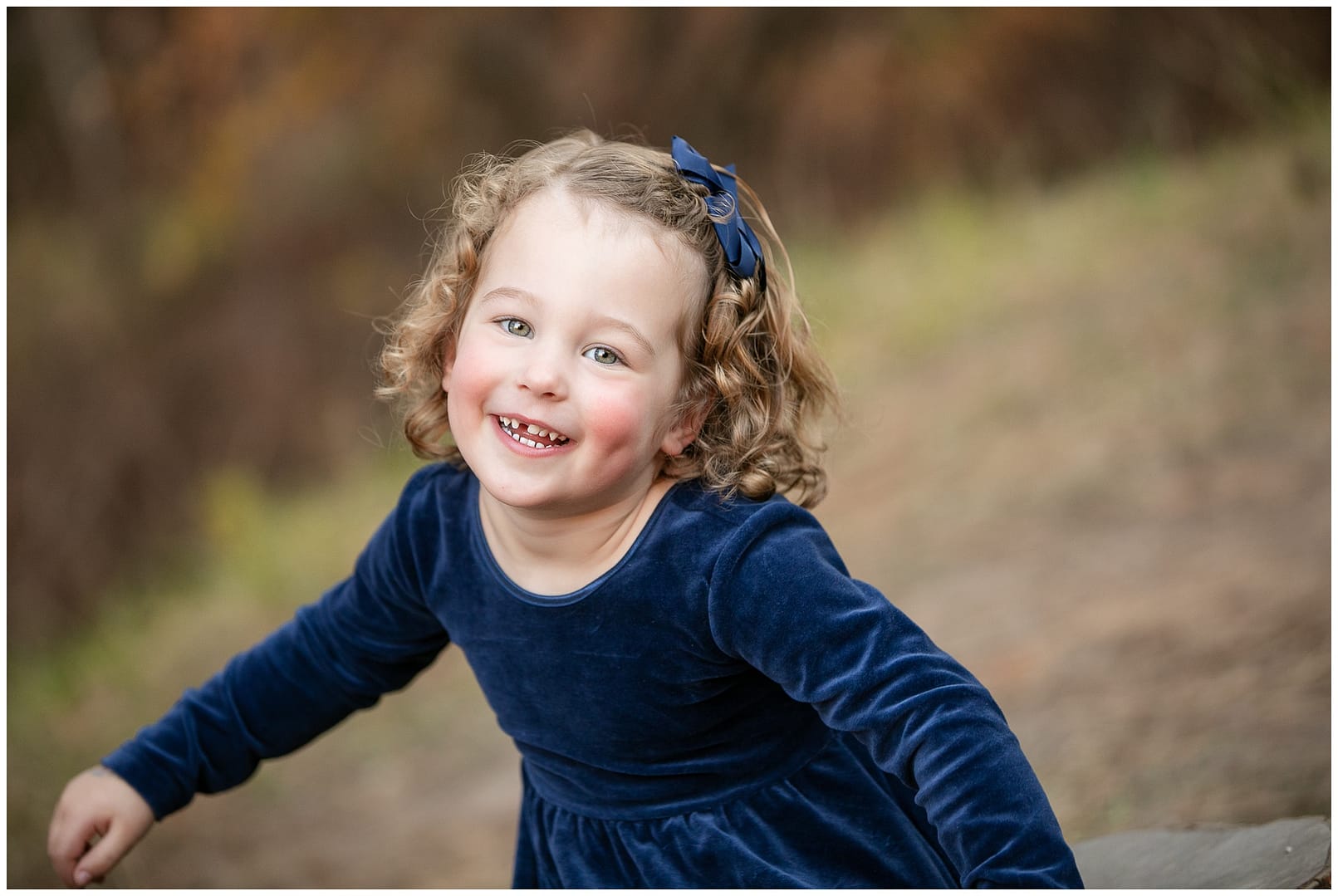 Little girl smiles candidly. Photo by Tiffany Hix Photography.