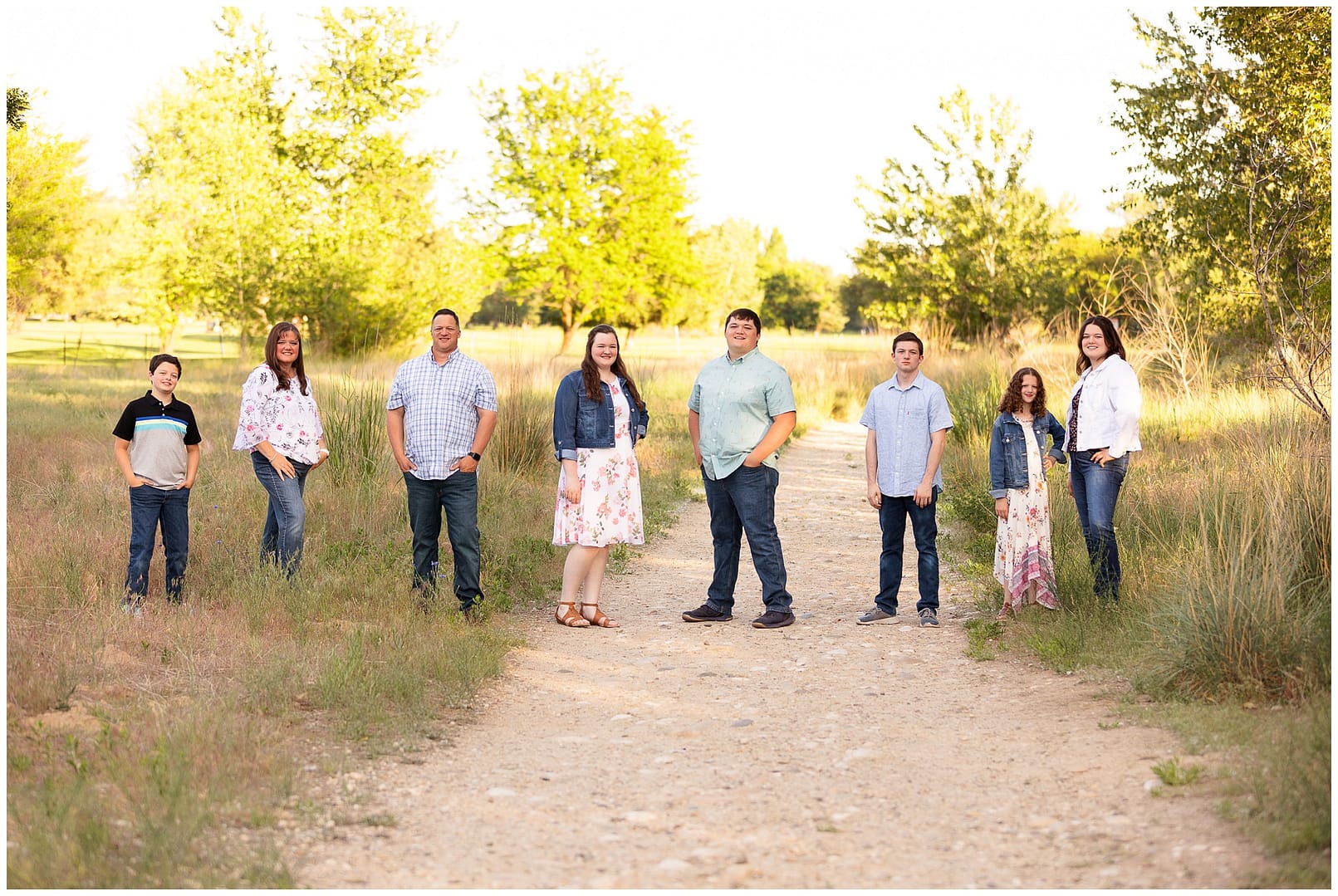 Large family stands apart while posing for photo. Photo by Tiffany Hix Photography.