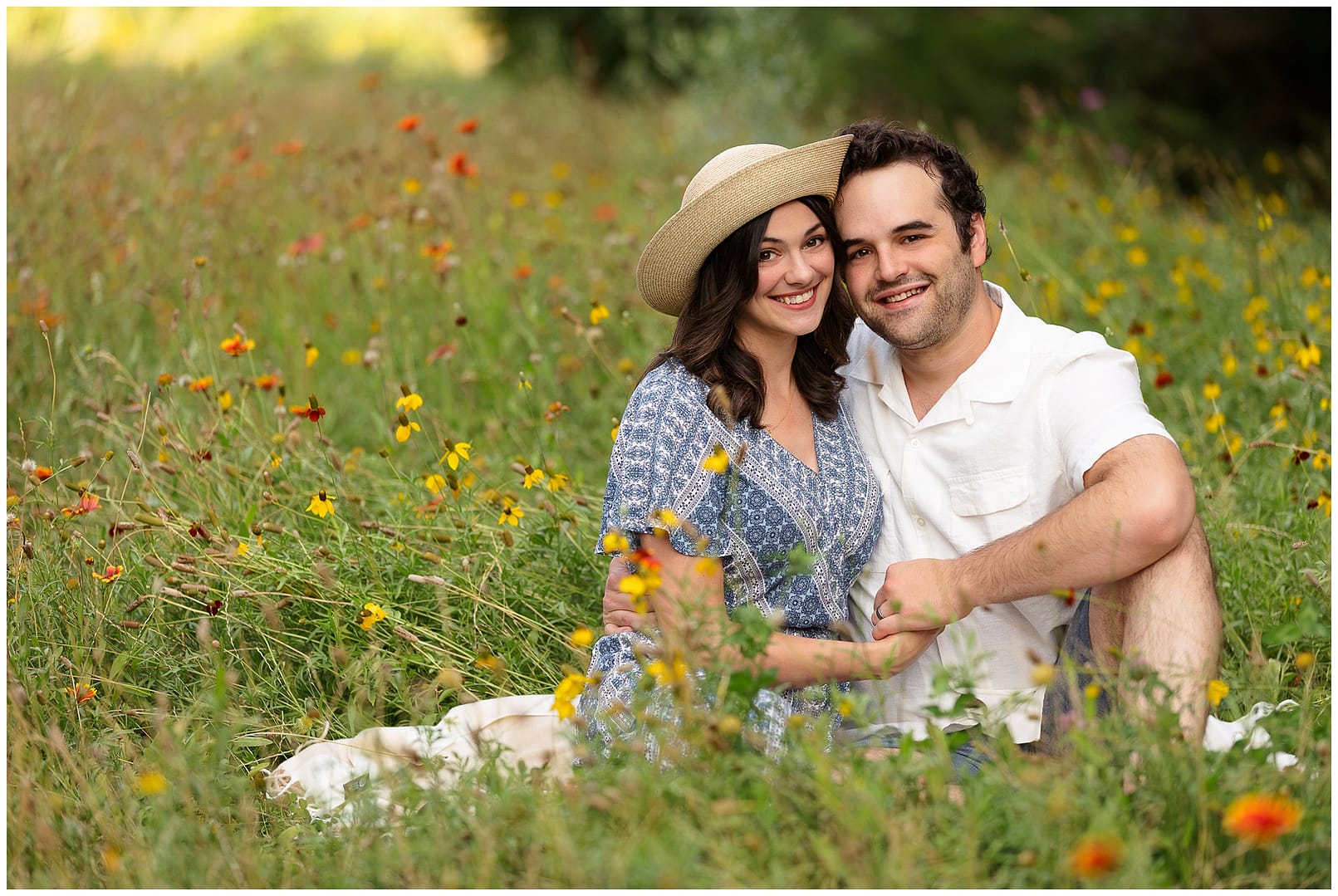Mom & Dad pose for a portrait amongst the wildflowers. Photo by Tiffany Hix Photography.