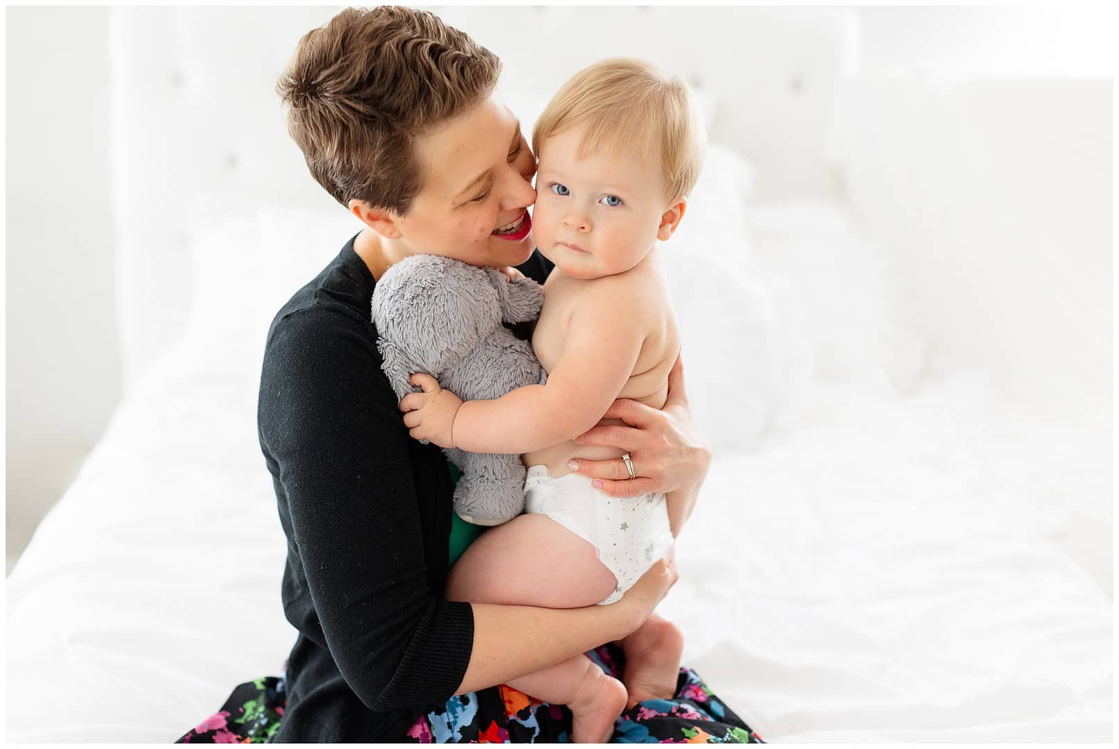 Mom snuggles into baby boy during milestone session. Photo by Tiffany Hix Photography. 