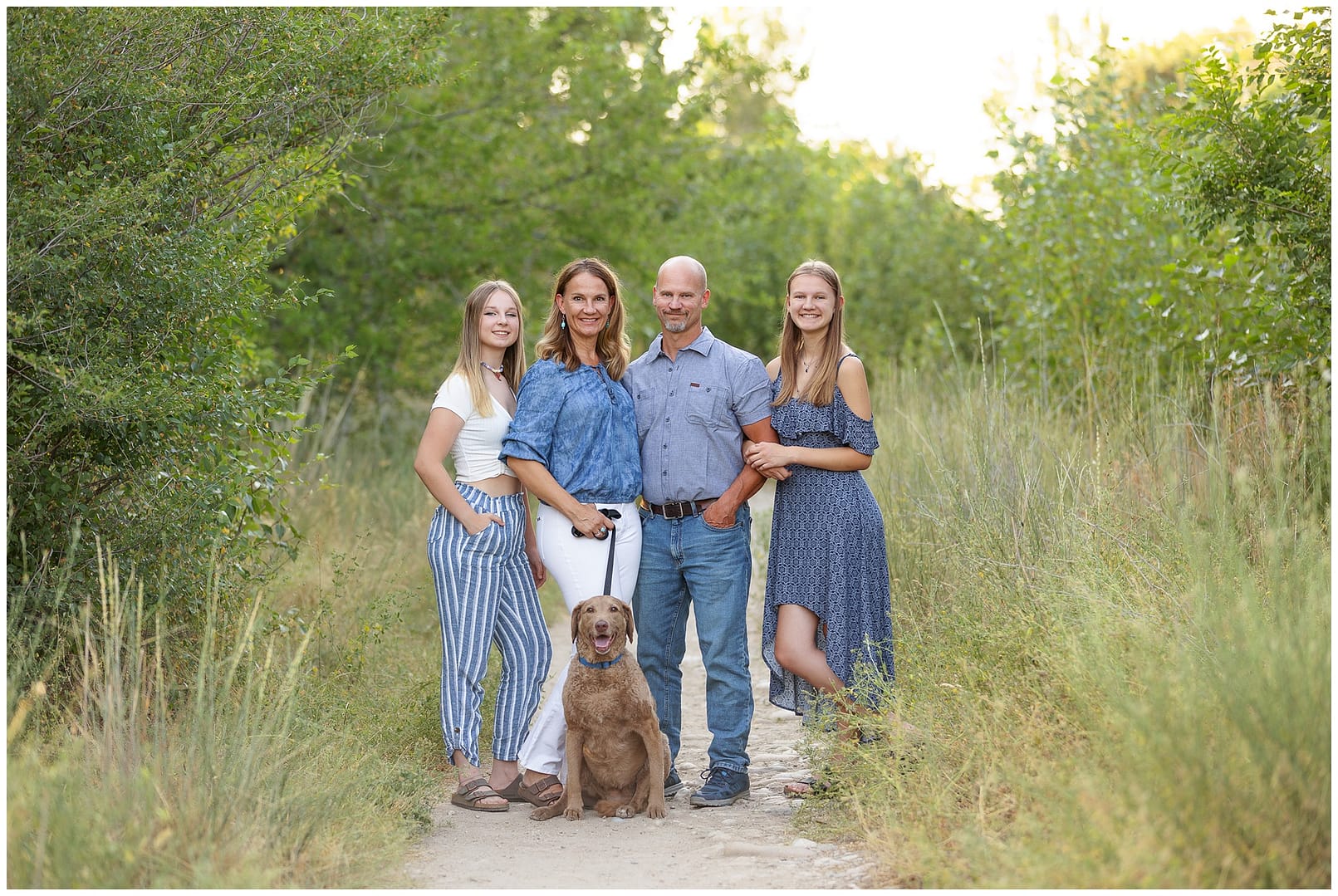 Family of four with dog on the Boise greenbelt. Photo by Tiffany Hix Photography.