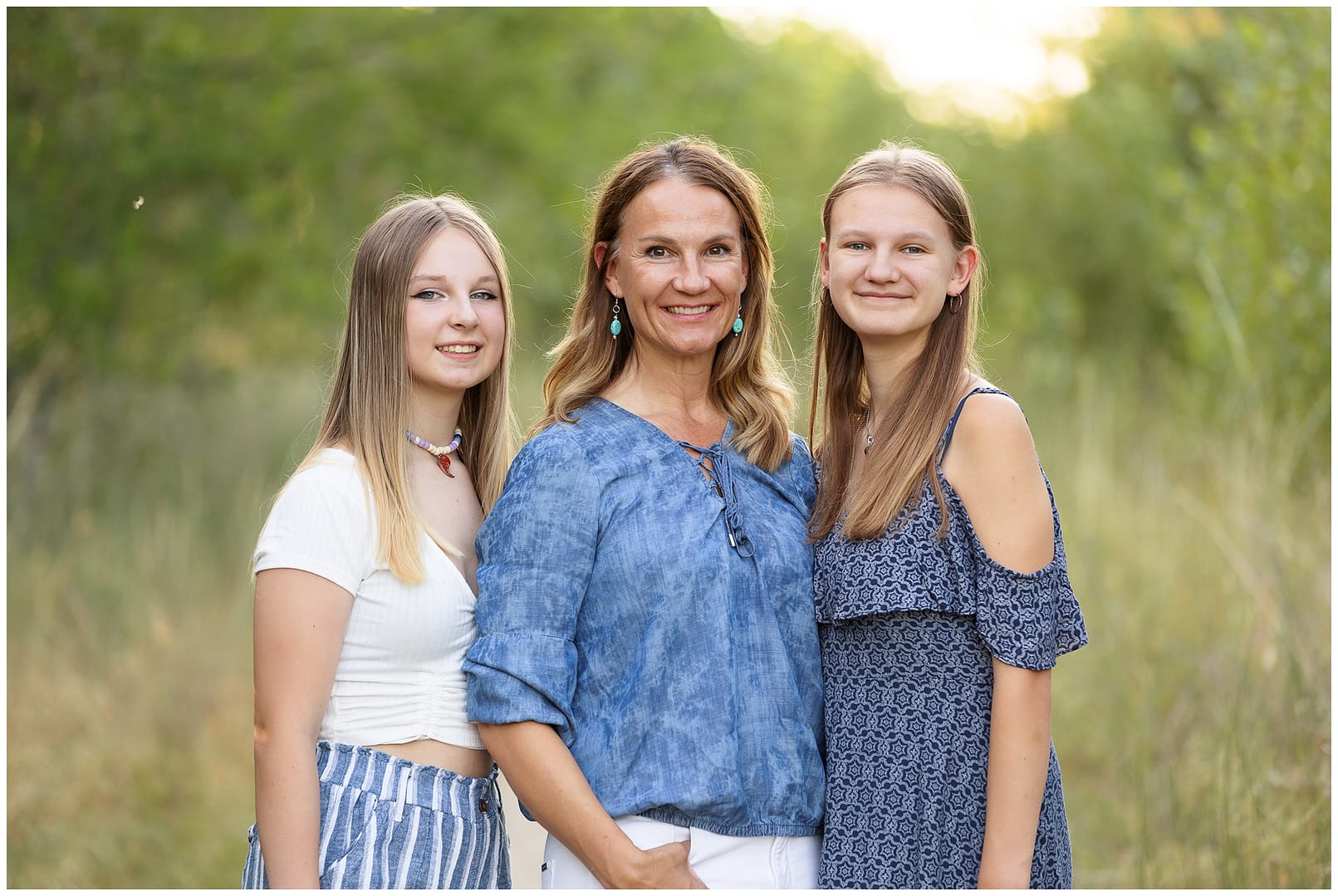 Mom and her two daughters smile for portrait. Photo by Tiffany Hix Photography.