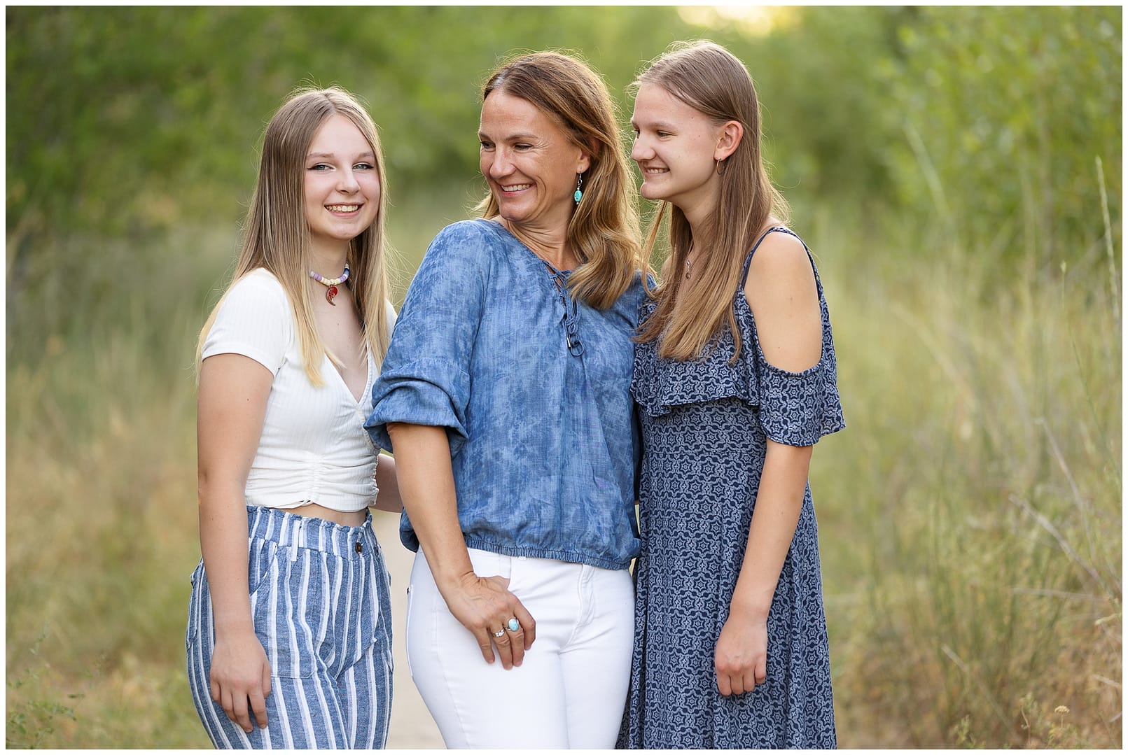 Mom and two daughters giggle during family photo shoot. Photo by Tiffany Hix Photography.