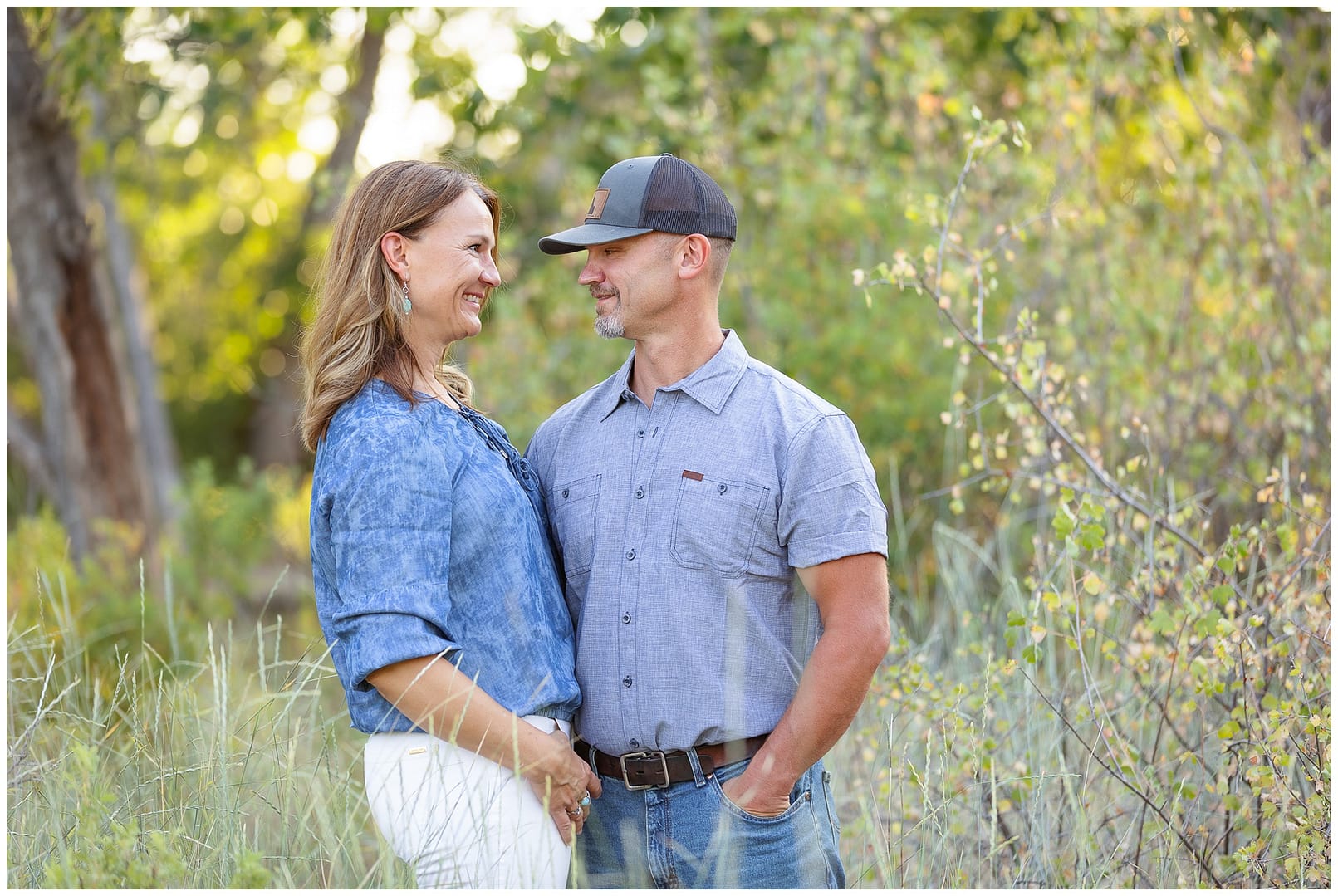 Mom and dad lovingly look at one another during family photos on the Boise greenbelt. Photo by Tiffany Hix Photography.