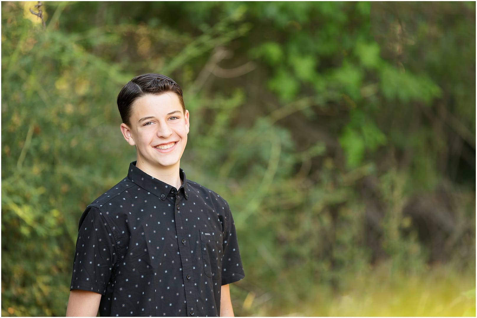 Boy smiles for portrait. Photo by Tiffany Hix Photography.