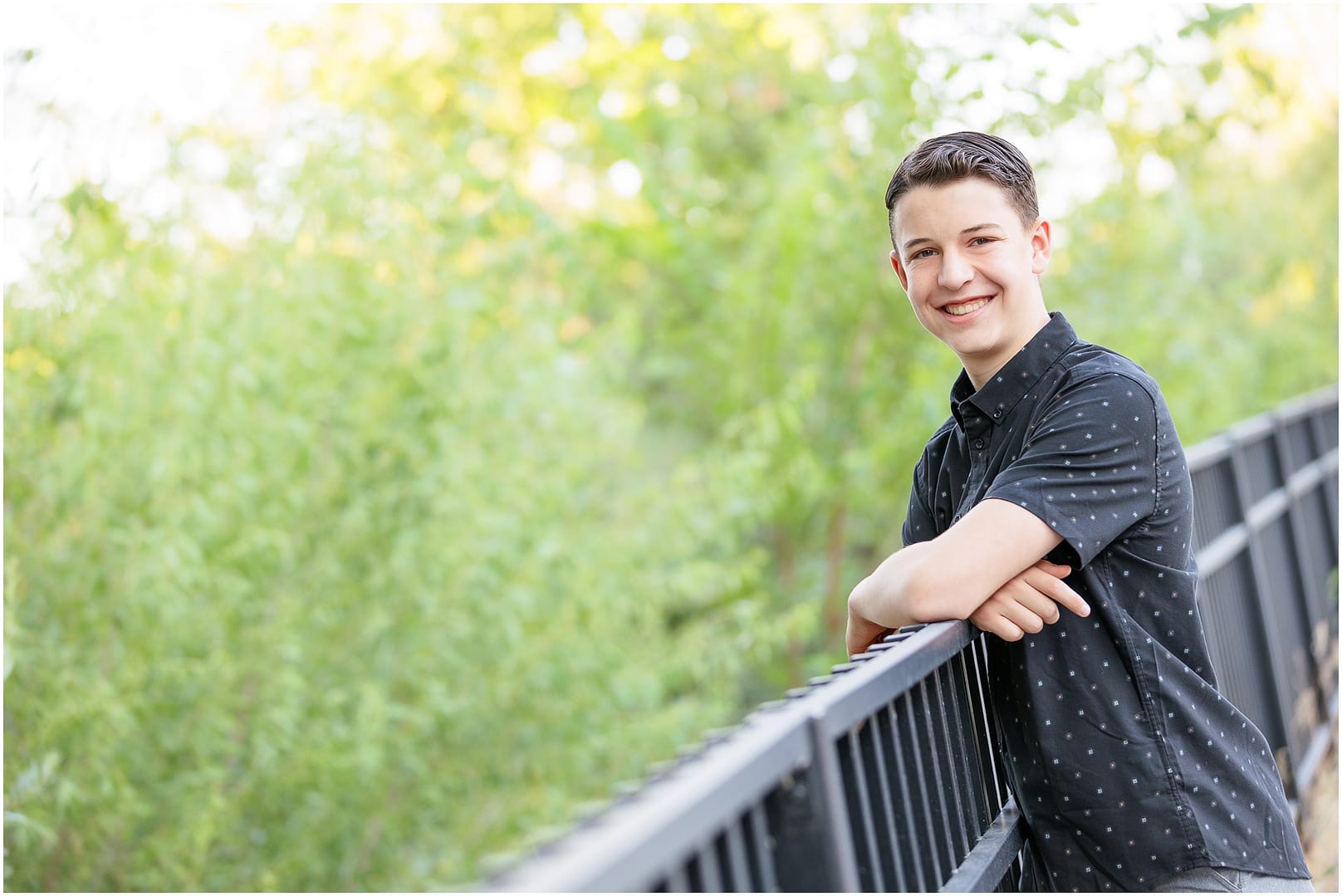 Teen by leans against fence during portrait session in Boise. Photo by Tiffany Hix Photography.
