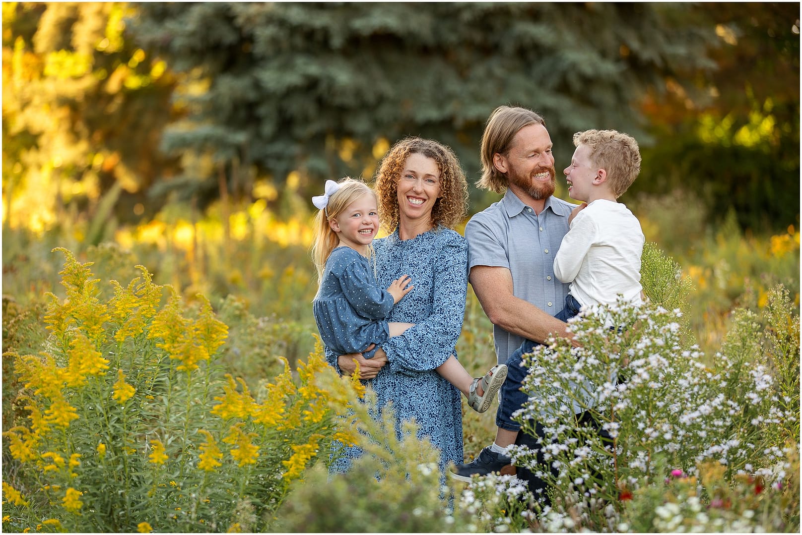 Family of four laughs during photo session. Photo by Tiffany Hix Photography.