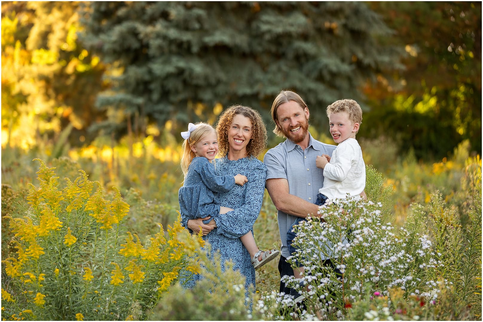 Family of four smiles big during Boise family photos. Photo by Tiffany Hix Photography.
