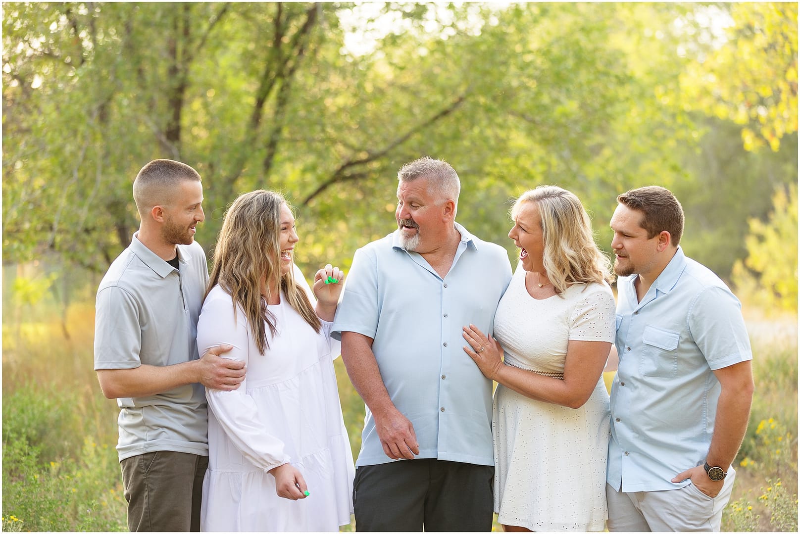 Daughter surprises family with pregnancy announcement during Boise family photo session. Photo by Tiffany Hix Photography.