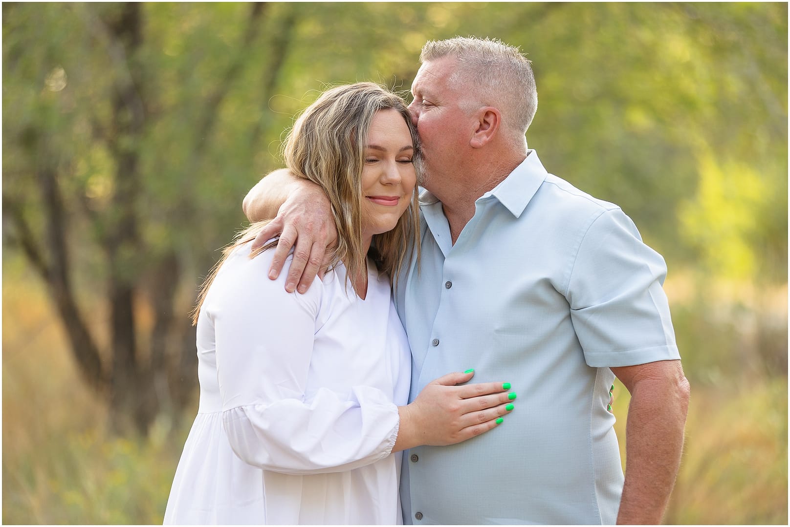 Dad embraces newly pregnant daughter. Photo by Tiffany Hix Photography.