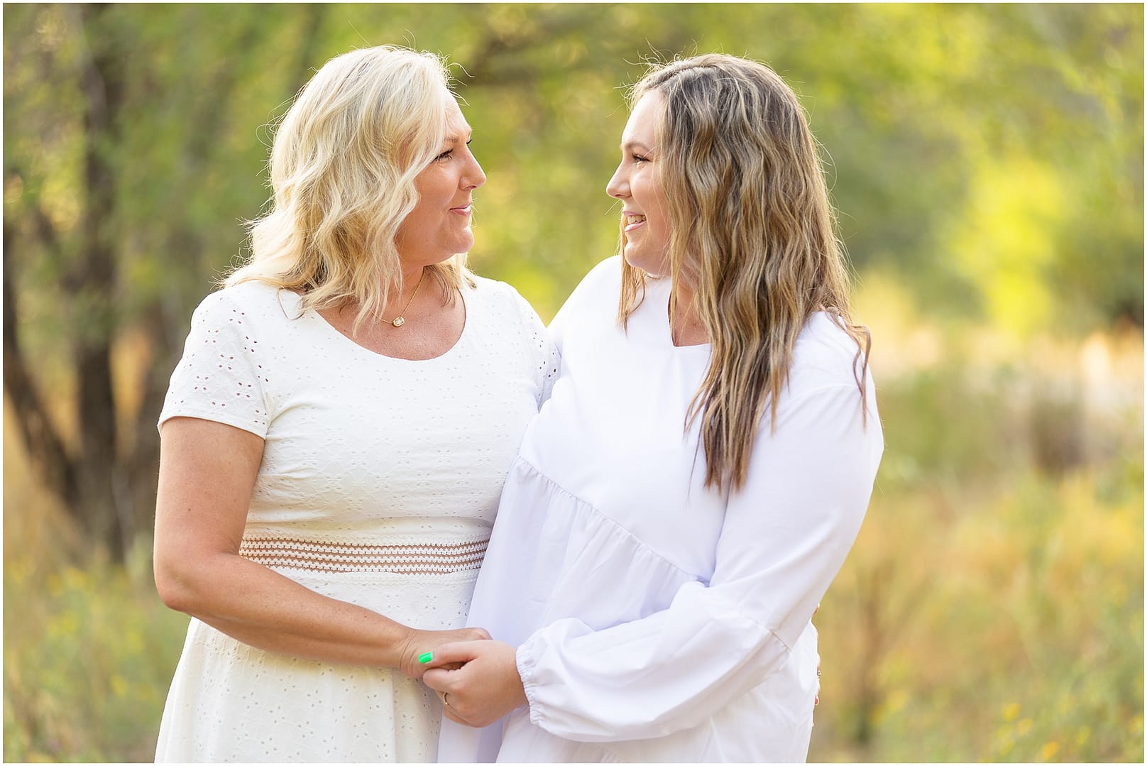 Mom and daughter hold hands during Boise family photoshoot. Photo by Tiffany Hix Photography.