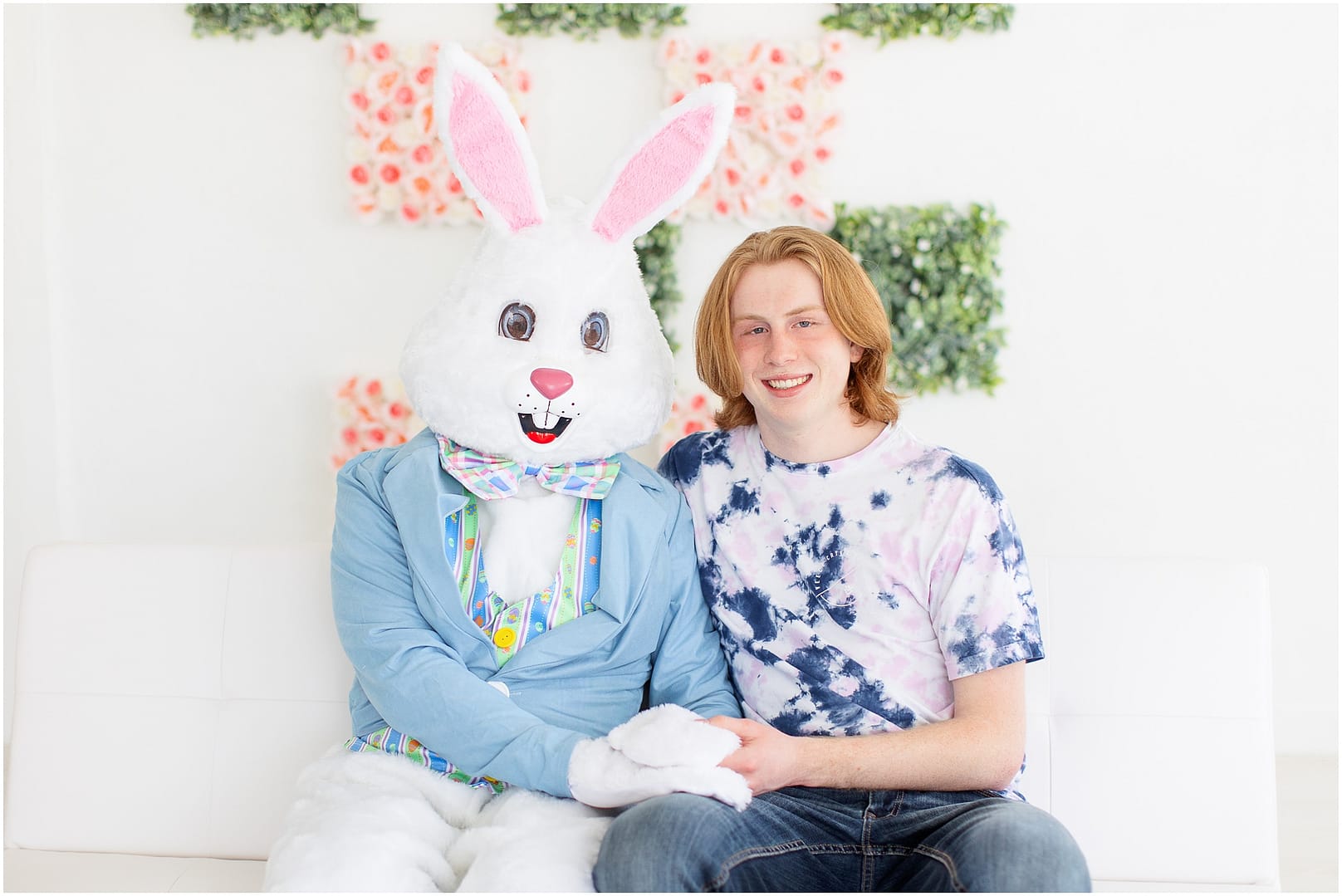 Tween boy holds hands with the Easter Bunny. Photo by Tiffany Hix Photography.