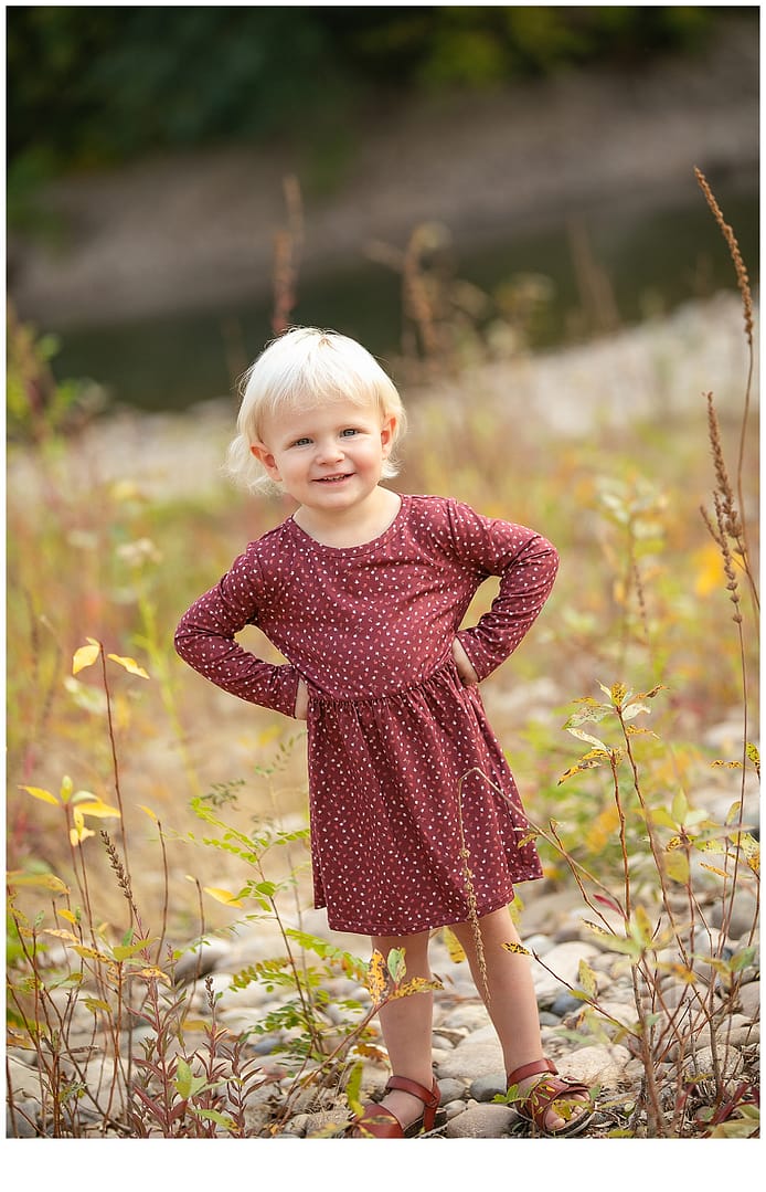 Three year old poses by the Boise River. Photo by Tiffany Hix Photography.