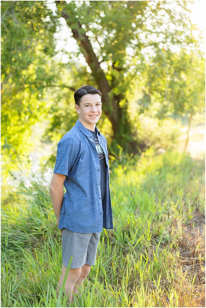 Boy stands in tall grasses during Boise portrait session. Photo by Tiffany Hix Photography.