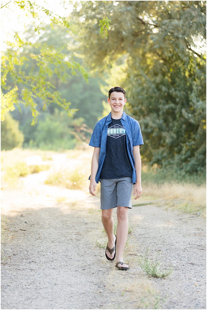 Boy walks along gravel pathway during Boise teen session. Photo by Tiffany Hix Photography.