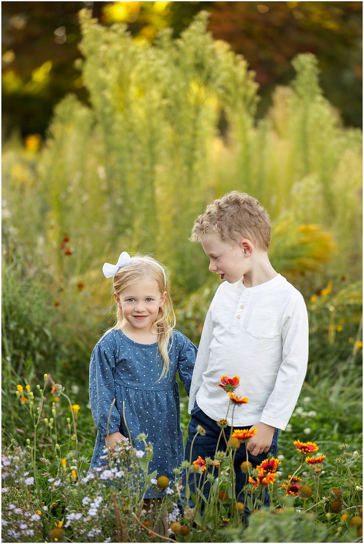 Brother looks at smiling sister during Boise family photos. Photo by Tiffany Hix Photography.