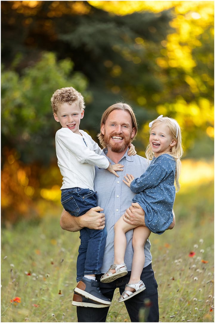 Dad holds his two toddlers in his arms. Photo by Tiffany Hix Photography.