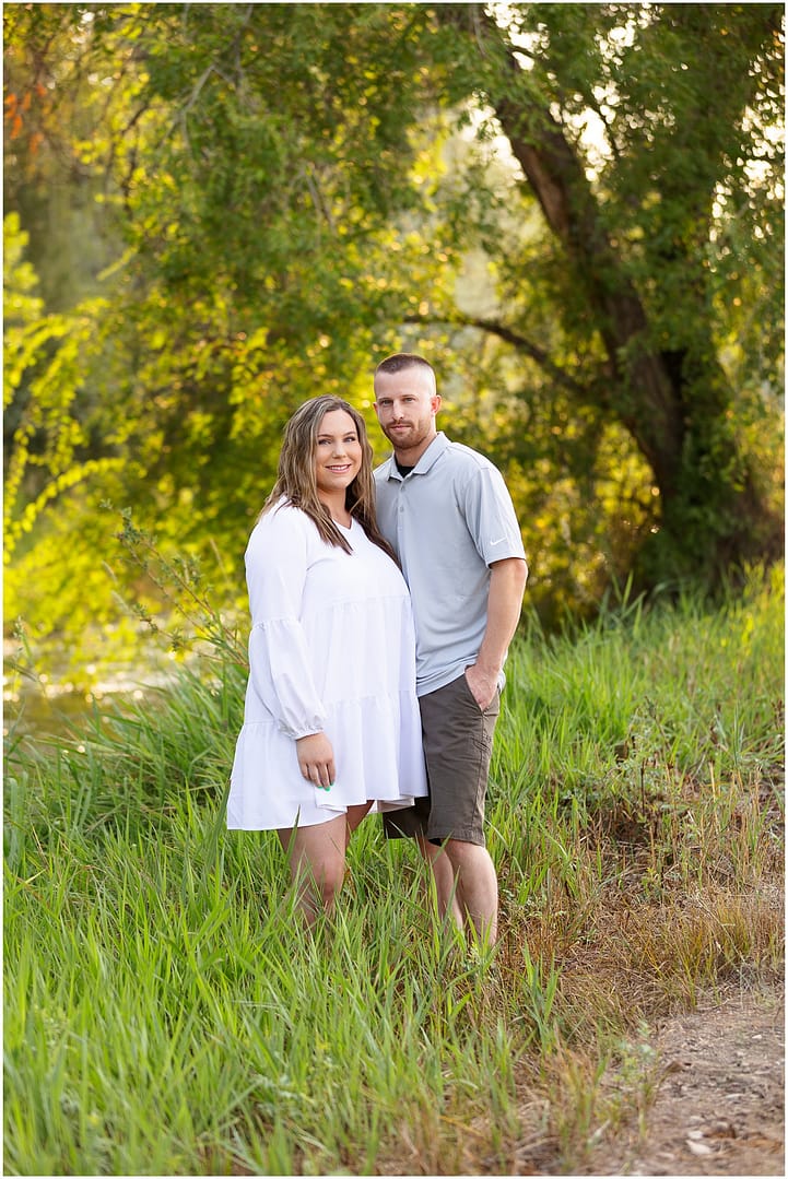 Young couple stands in marsh for photograph. Photo by Tiffany Hix Photography.