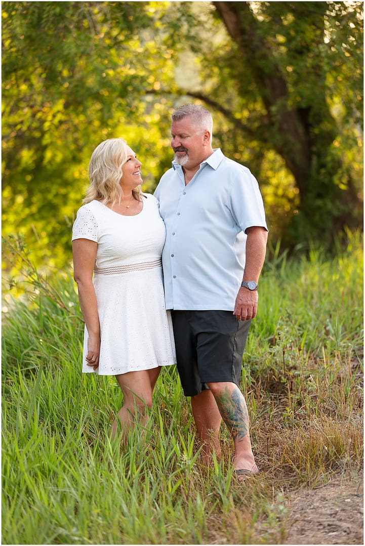 Mom and Dad smile at one another during family photo session in Boise. Photo by Tiffany Hix Photography.