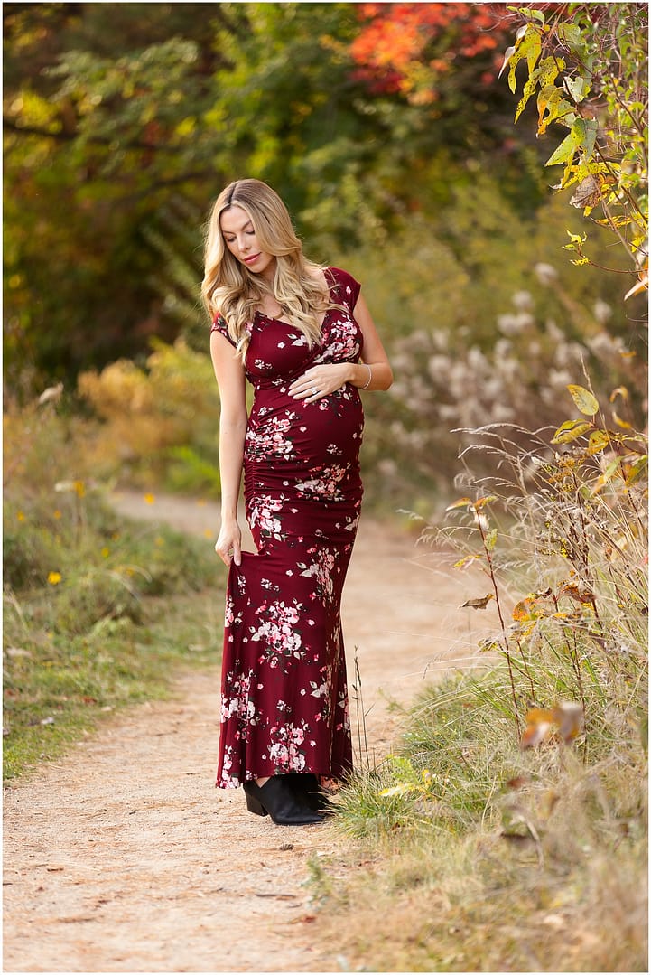 Mom to be stands along pathway during maternity session. Photo by Tiffany Hix Photography.