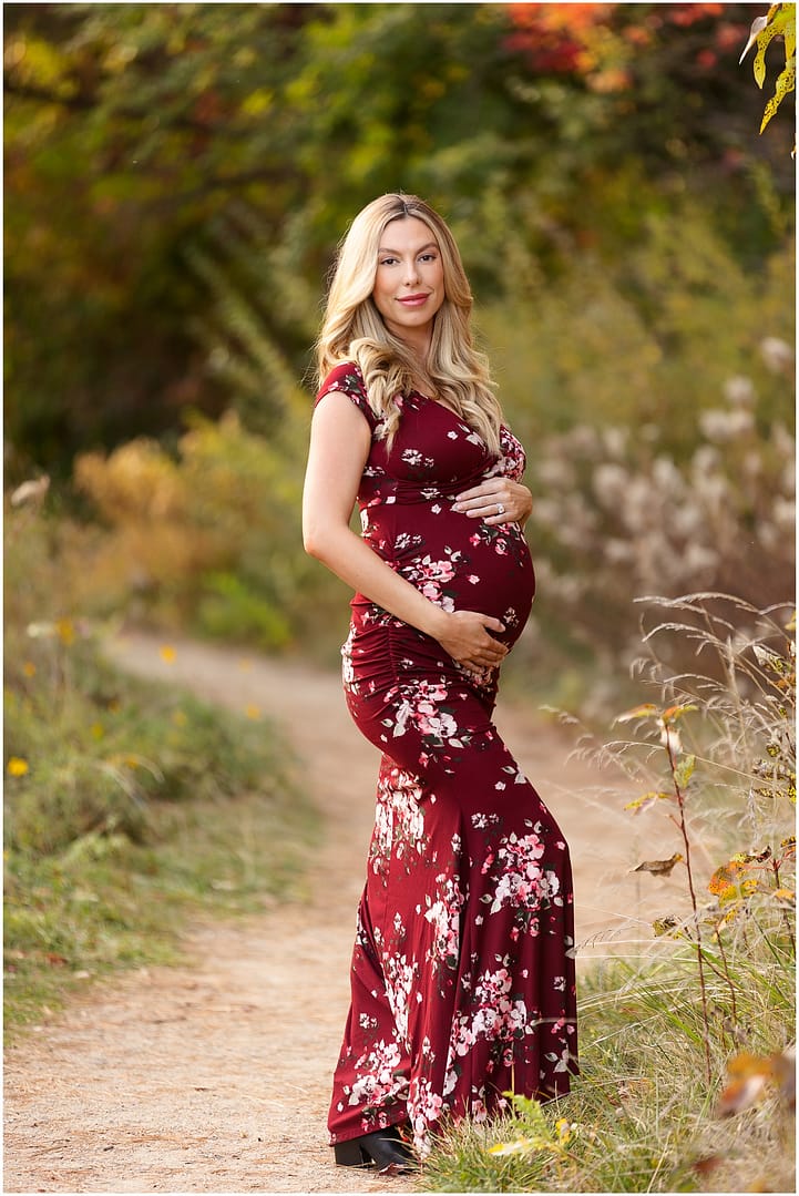 Mom to be holds bump during maternity session. Photo by Tiffany Hix Photography.