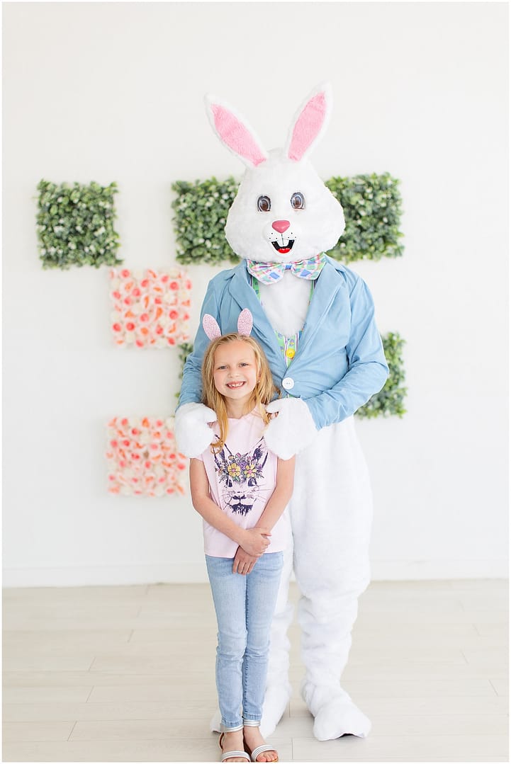 Little girl stands with Easter Bunny in Boise studio session. Photo by Tiffany Hix Photography.