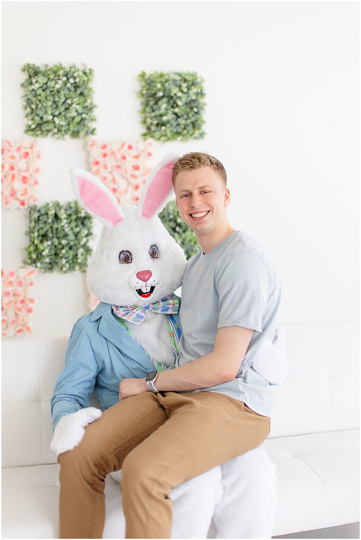 Teenage boy sits on top of Easter Bunny during studio session. Photo by Tiffany Hix Photography.