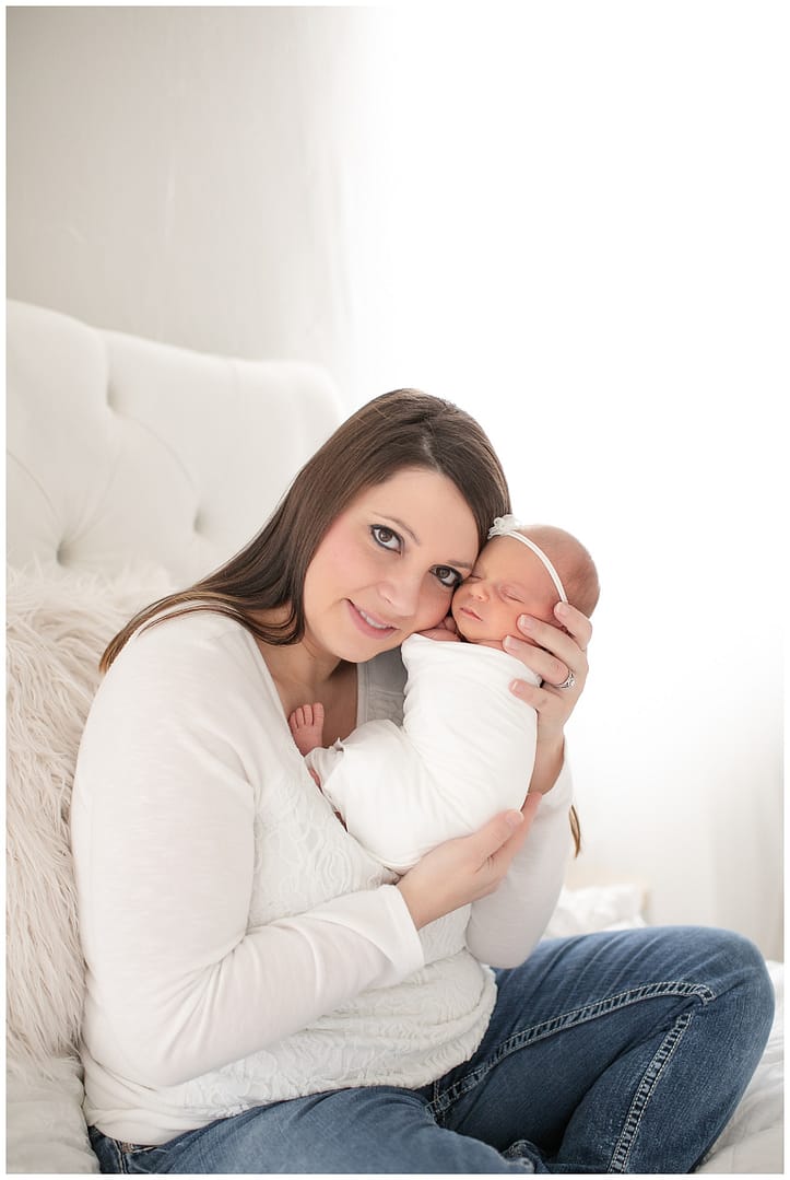 Mom poses with baby in studio. Photo by Tiffany Hix Photography.