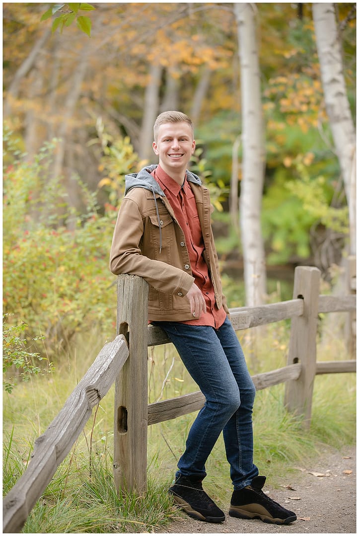 Young man poses for portrait. Photo by Tiffany Hix Photography.