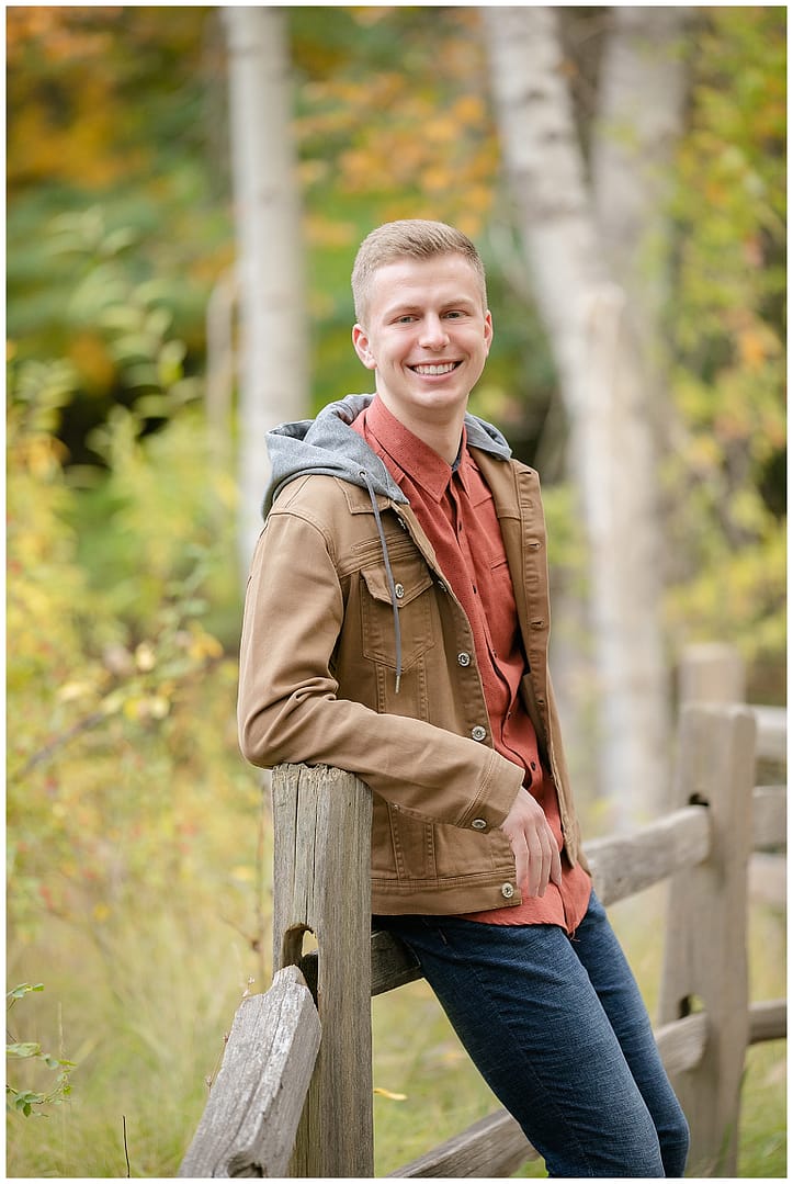 Young man poses for photograph. Photo by Tiffany Hix Photography.