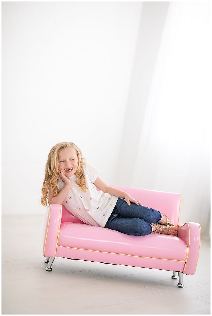 Child on pink couch. Photos by Tiffany Hix Photography.