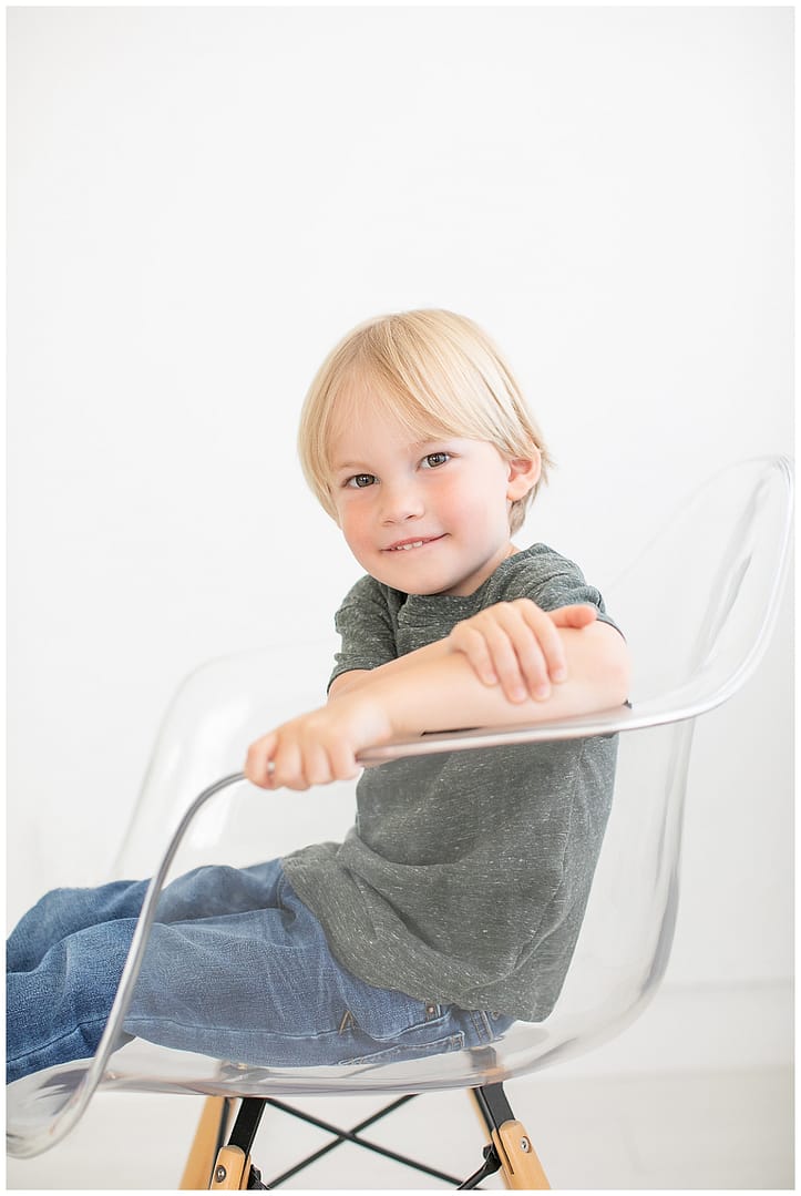 Young boy smiles for portrait in studio. Photos by Tiffany Hix Photography.