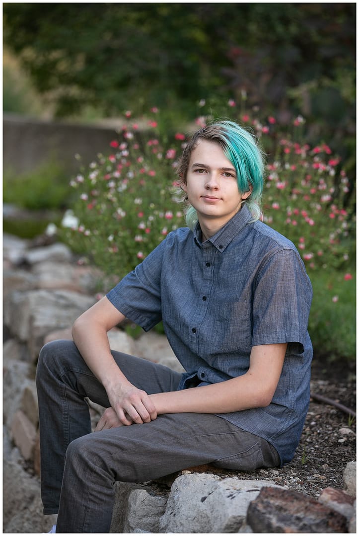 Young adult with blue hair poses for photograph. Photo by Tiffany Hix.