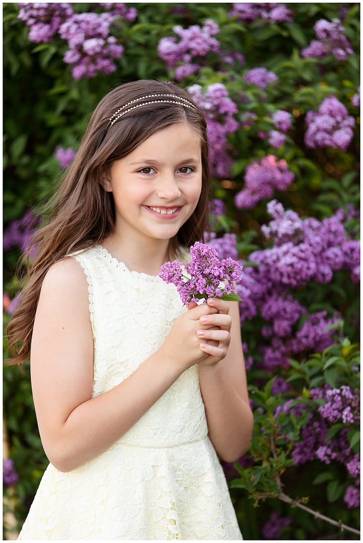 Young lady poses with lilacs. Photos by Tiffany Hix Photography.