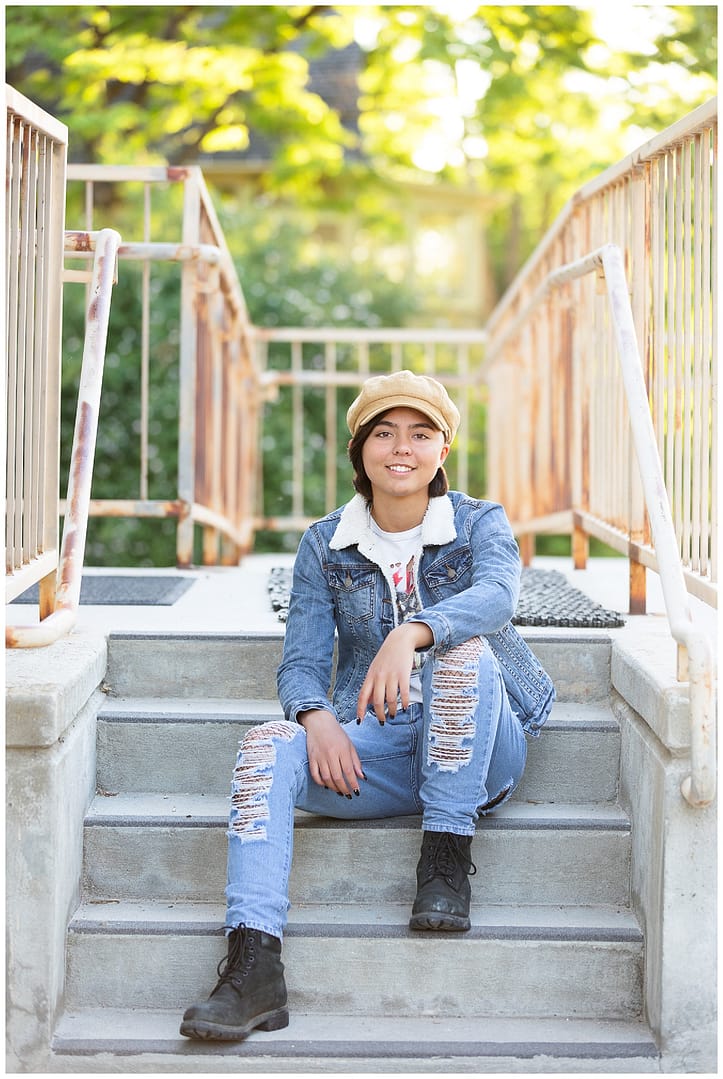 Girl sits on stairs in denim outfit. Photo by Tiffany Hix Photography.