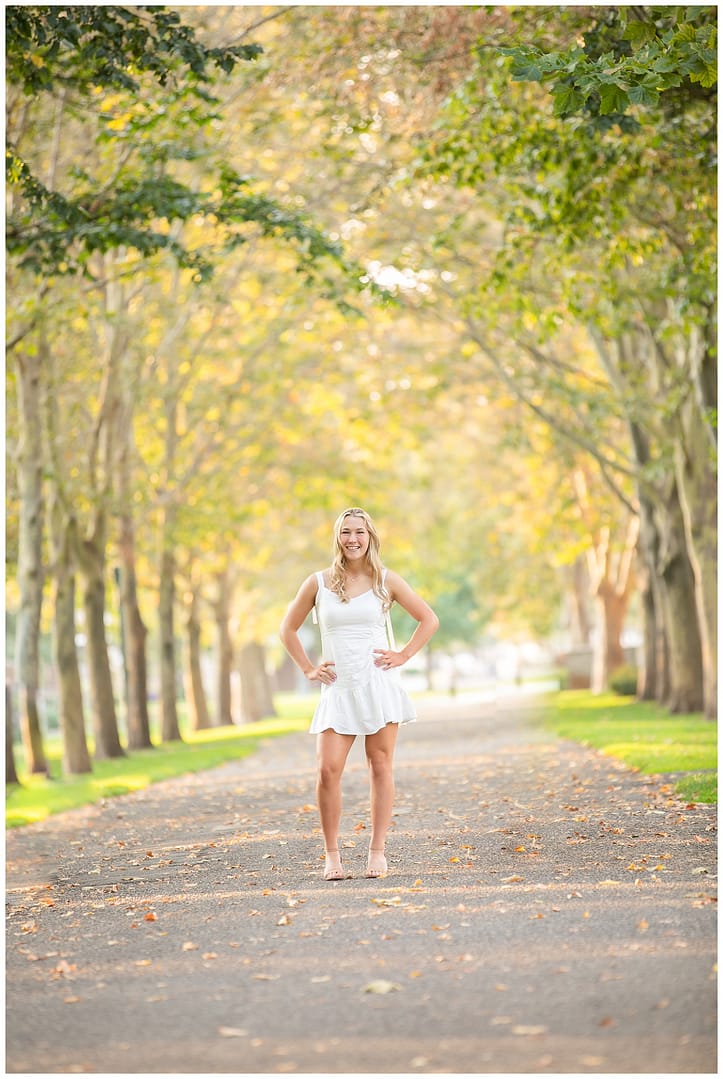 Boise senior stands in ally lined with trees. Photo by Tiffany Hix Photography.