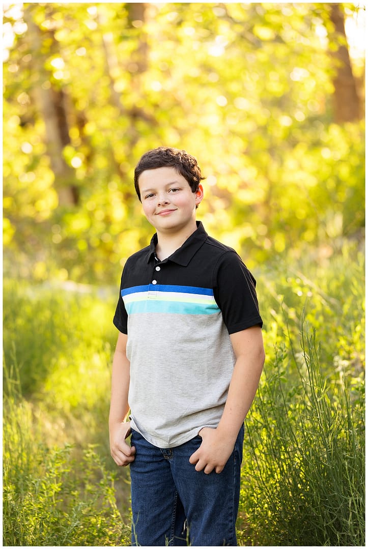 Young boy poses for photograph at Boise river. Photo by Tiffany Hix Photography.