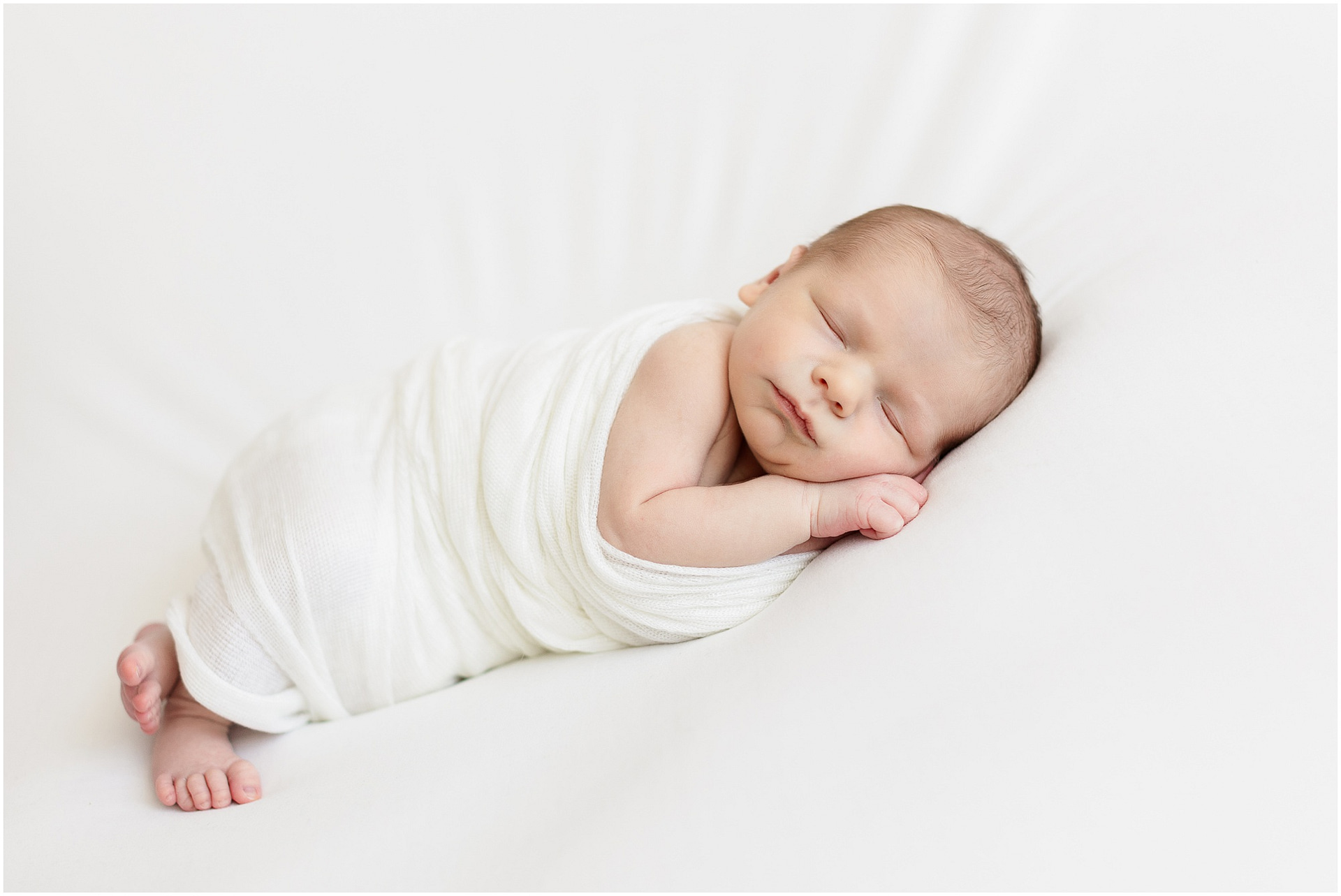 Baby boy peacefully sleeps during Boise newborn session. Photo by Tiffany Hix Photography.