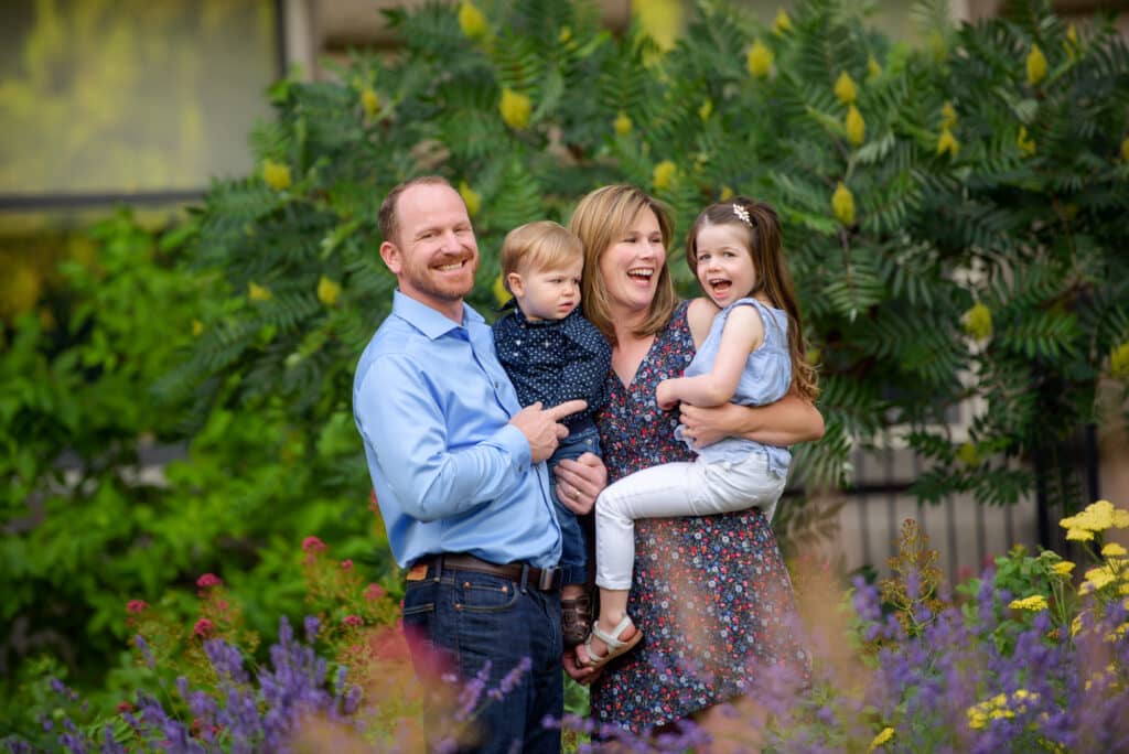 Family of 4 laughing and looking at each other during Boise family photography session with Tiffany Hix